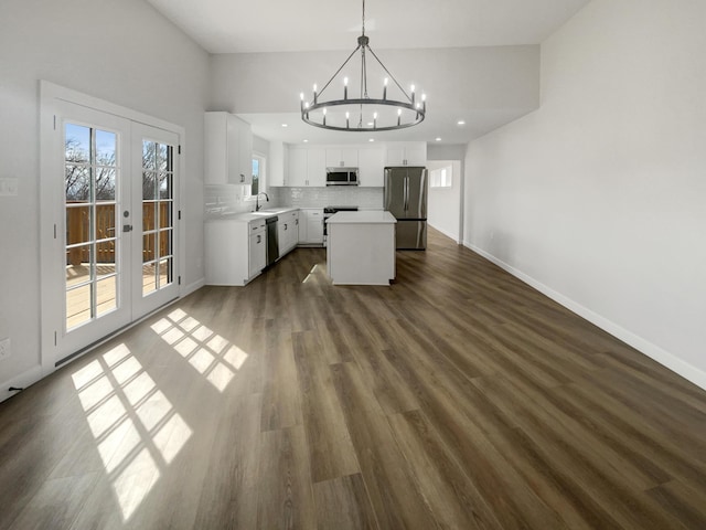 kitchen featuring a chandelier, appliances with stainless steel finishes, french doors, and a sink