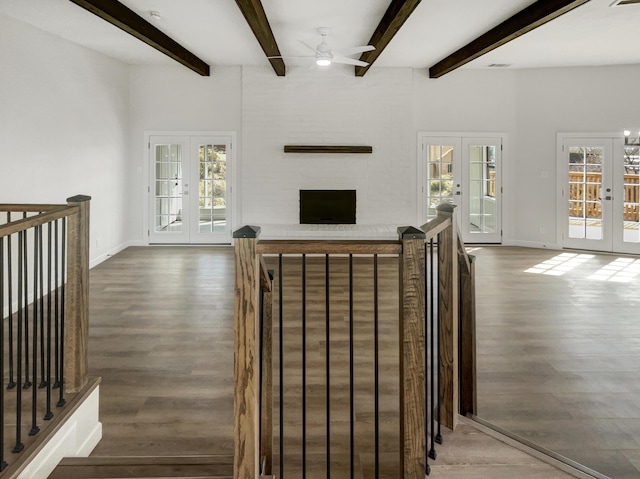 unfurnished living room with wood finished floors, french doors, plenty of natural light, and ceiling fan