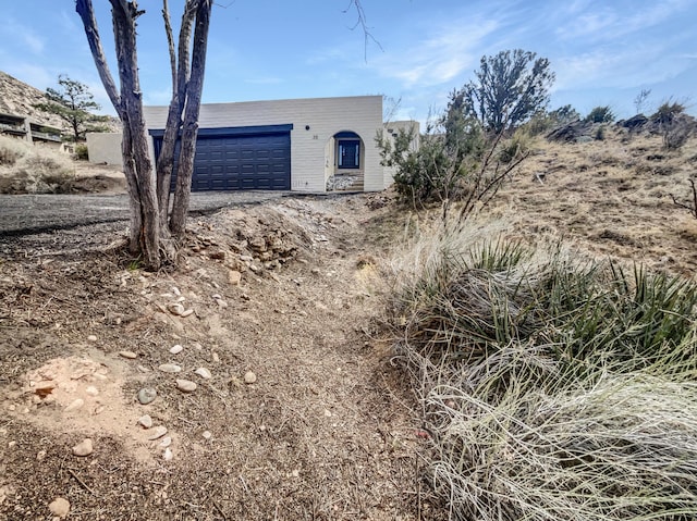 view of front facade featuring an outdoor structure and an attached garage