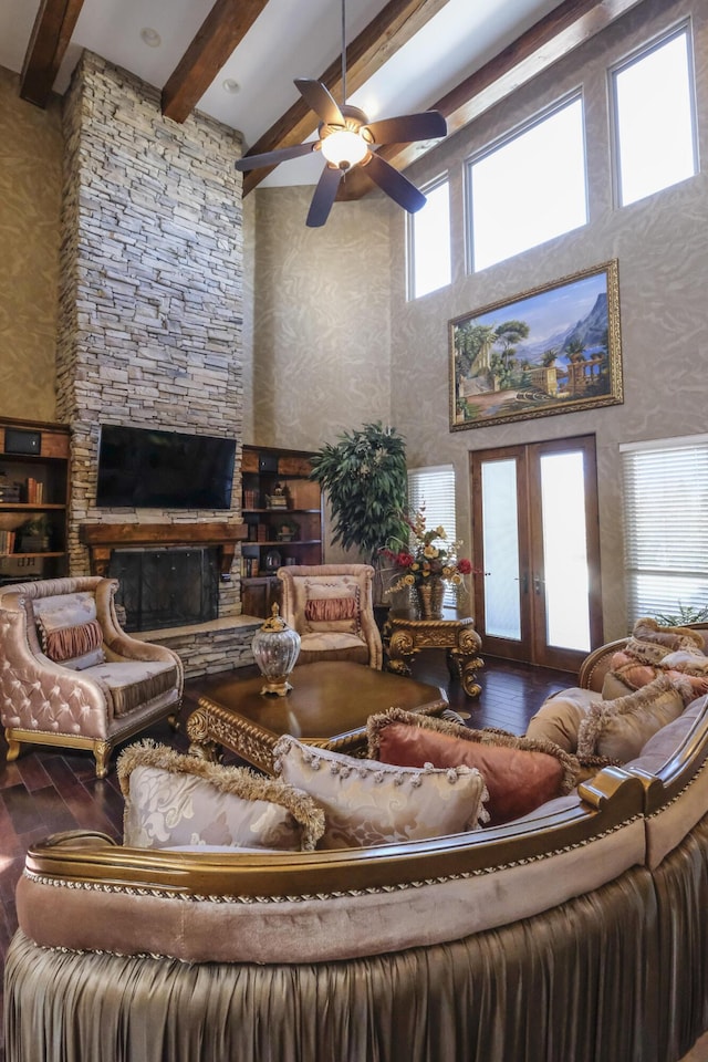 living room featuring beamed ceiling, wood finished floors, french doors, and ceiling fan