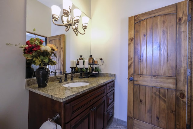 bathroom featuring an inviting chandelier and vanity