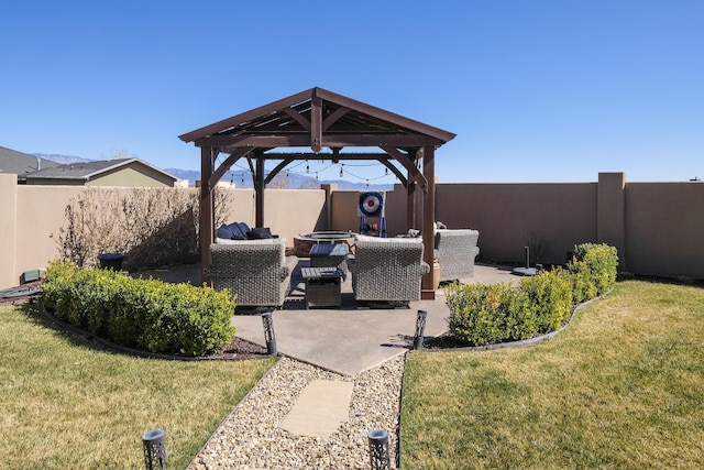 view of patio featuring a gazebo, an outdoor living space, and fence