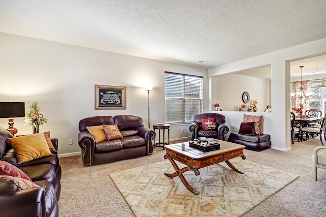living area with a notable chandelier, carpet flooring, a textured ceiling, and baseboards