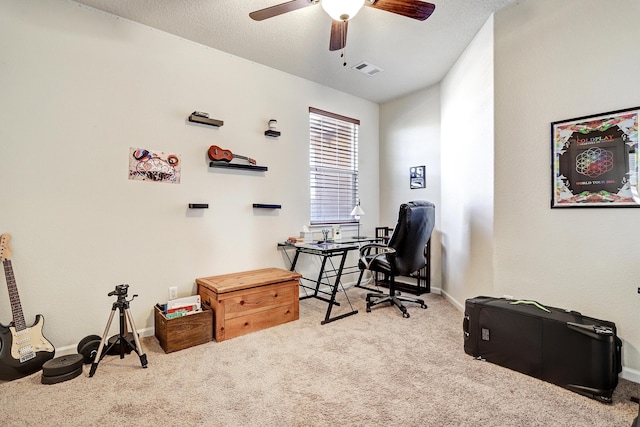 office space featuring visible vents, carpet floors, a textured ceiling, and ceiling fan