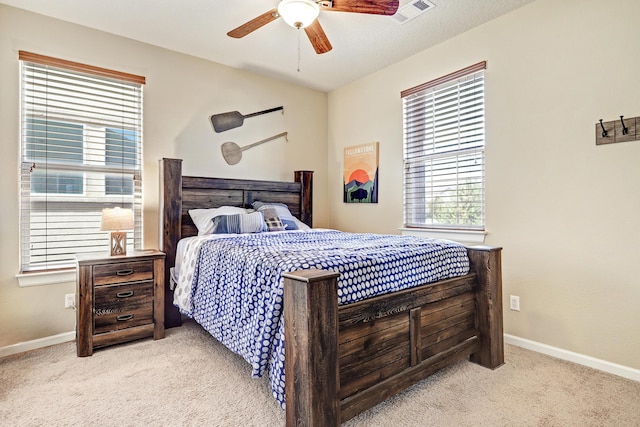 bedroom featuring visible vents, baseboards, a ceiling fan, and carpet flooring