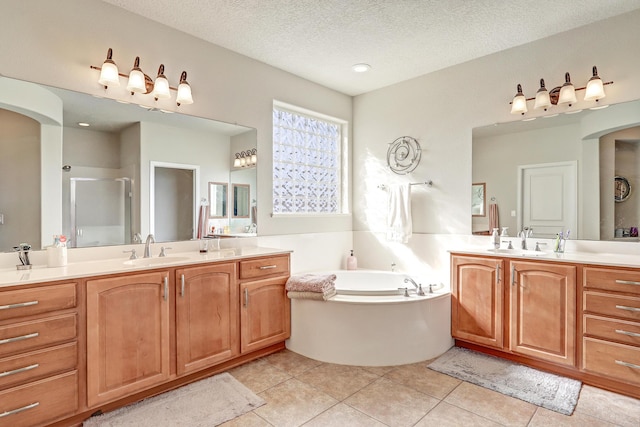 bathroom with a sink, two vanities, a shower stall, and tile patterned floors