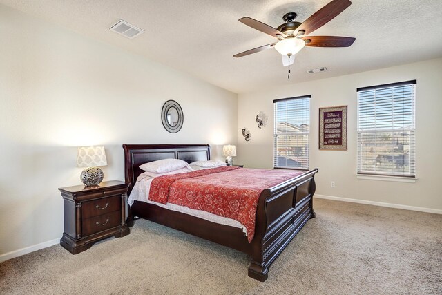 bedroom featuring baseboards, visible vents, and light carpet