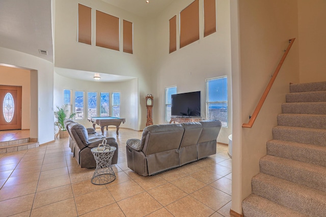 living room featuring light tile patterned flooring, visible vents, stairs, and billiards