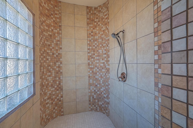 bathroom with a tile shower