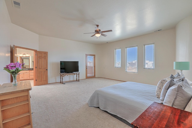 bedroom with visible vents, light colored carpet, and a ceiling fan