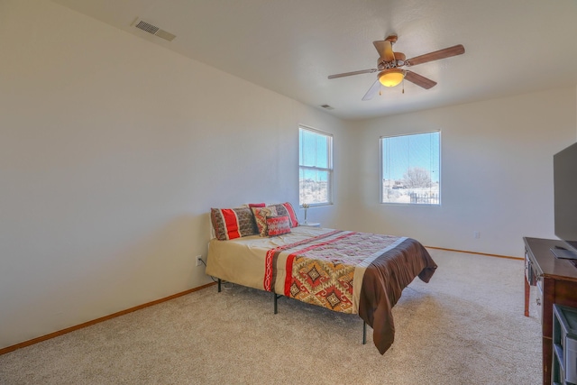 bedroom with visible vents, carpet floors, baseboards, and a ceiling fan