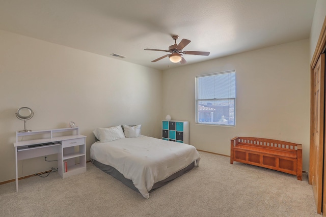 bedroom featuring light carpet, visible vents, ceiling fan, and baseboards