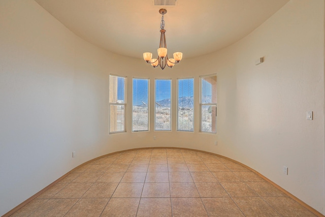 empty room featuring light tile patterned floors, visible vents, baseboards, and a chandelier