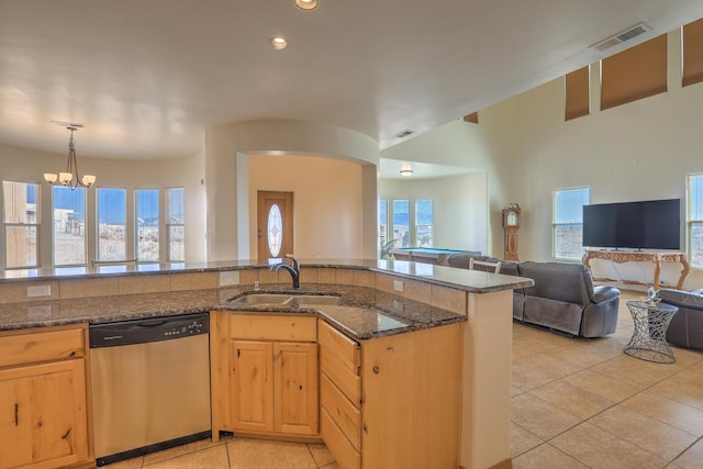 kitchen featuring dishwasher, visible vents, open floor plan, and a sink