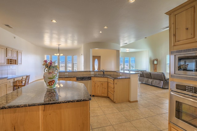 kitchen with visible vents, a kitchen island, open floor plan, appliances with stainless steel finishes, and light tile patterned floors