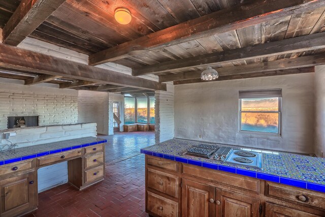 3805 Riverview Rd NW, Albuquerque, NM 87105 - kitchen featuring a wood ceiling with exposed beams, brick flooring, tile countertops, healthy amount of natural light, and stainless steel electric cooktop