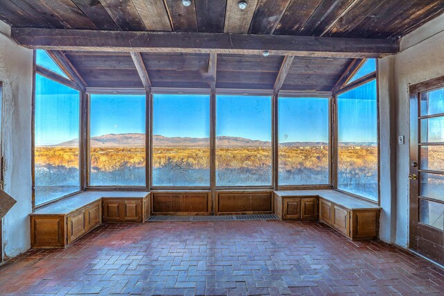 3805 Riverview Rd NW, Albuquerque, NM 87105 - unfurnished sunroom with wooden ceiling, brick flooring, and a mountain view