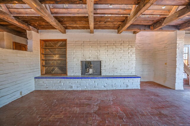 3805 Riverview Rd NW, Albuquerque, NM 87105 - unfurnished living room featuring a wood ceiling with exposed beams and brick floors