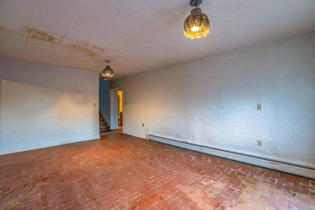 3805 Riverview Rd NW, Albuquerque, NM 87105 - empty room with a baseboard heating unit, stairs, brick flooring, and a chandelier