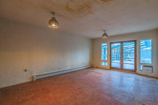 3805 Riverview Rd NW, Albuquerque, NM 87105 - empty room with a baseboard heating unit, french doors, a chandelier, and brick patterned flooring