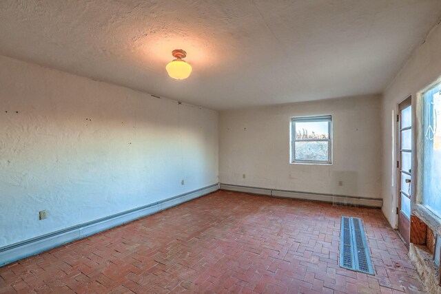 3805 Riverview Rd NW, Albuquerque, NM 87105 - unfurnished room featuring brick floors and baseboards