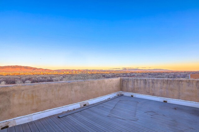 3805 Riverview Rd NW, Albuquerque, NM 87105 - deck at dusk featuring a mountain view