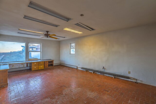 3805 Riverview Rd NW, Albuquerque, NM 87105 - empty room featuring brick floors, a desk, and ceiling fan
