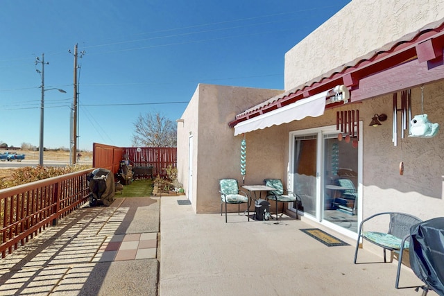 view of patio / terrace featuring fence