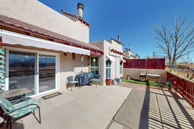 view of patio featuring fence