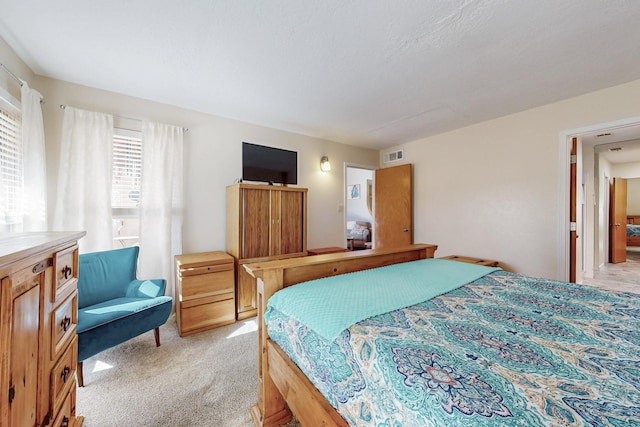 bedroom with light colored carpet and visible vents