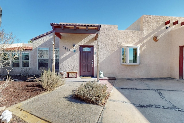 doorway to property with stucco siding