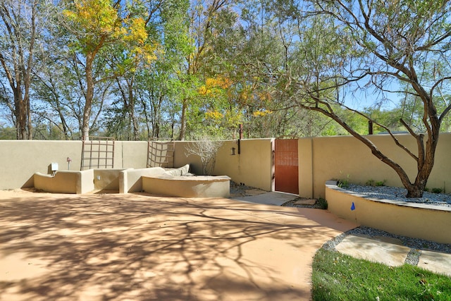 view of patio with fence and a gate