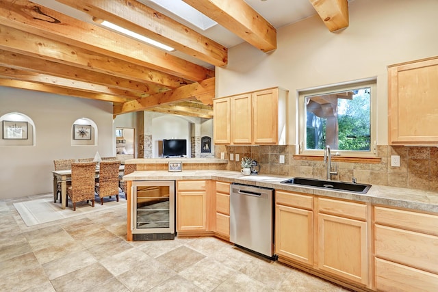 kitchen featuring light brown cabinetry, wine cooler, dishwasher, a peninsula, and a sink