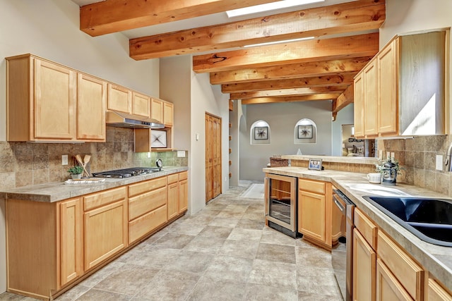 kitchen featuring wine cooler, light brown cabinets, stainless steel appliances, and under cabinet range hood