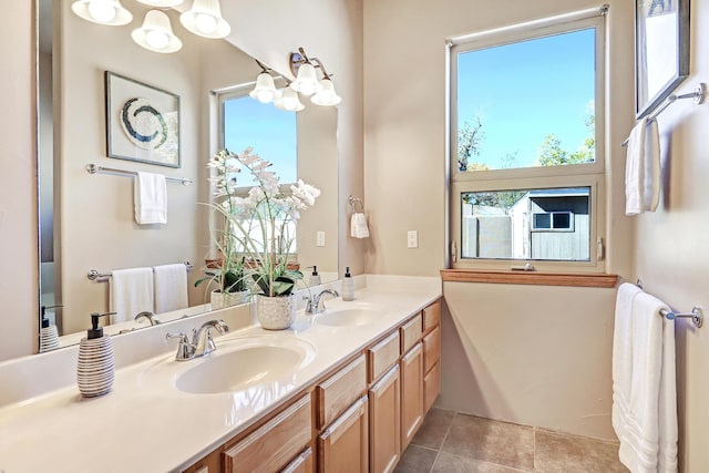 bathroom with a wealth of natural light, tile patterned flooring, and a sink