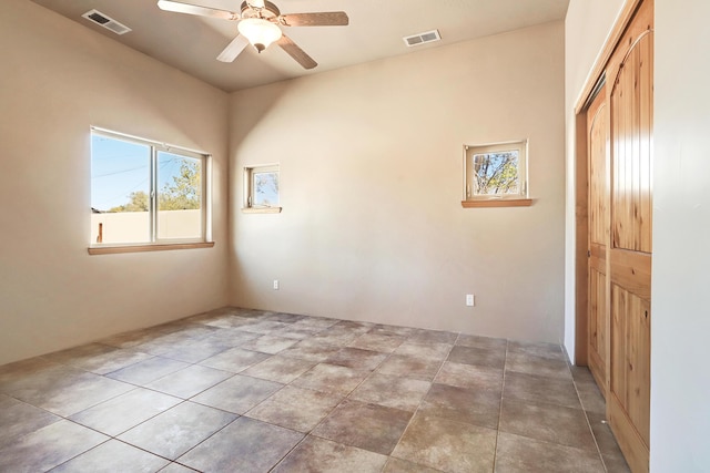 spare room with a ceiling fan and visible vents