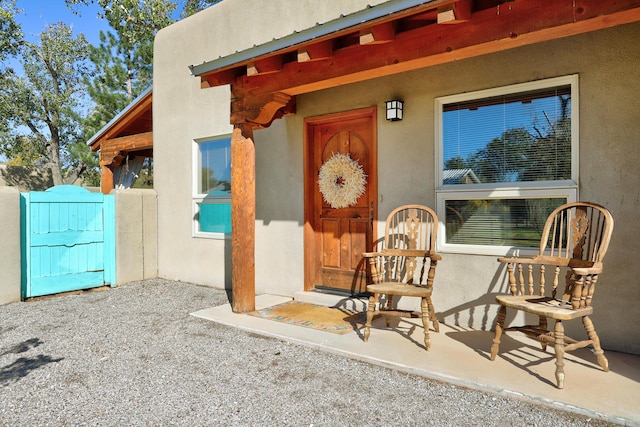 doorway to property featuring stucco siding