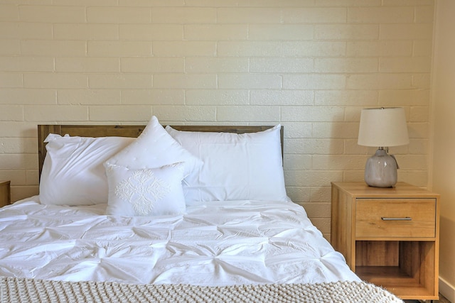 bedroom with brick wall