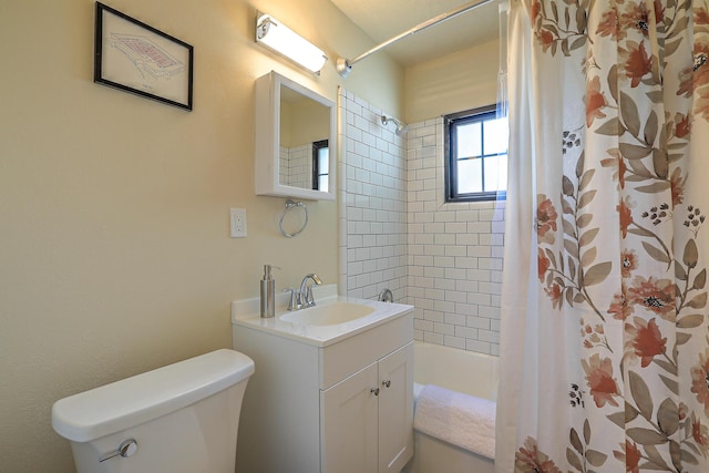 bathroom featuring vanity, shower / bath combination with curtain, and toilet