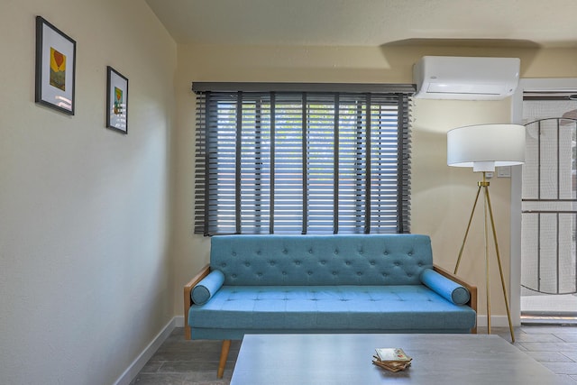 unfurnished room featuring an AC wall unit and baseboards