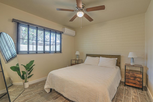 bedroom featuring ceiling fan, baseboards, a wall mounted air conditioner, and wood finish floors