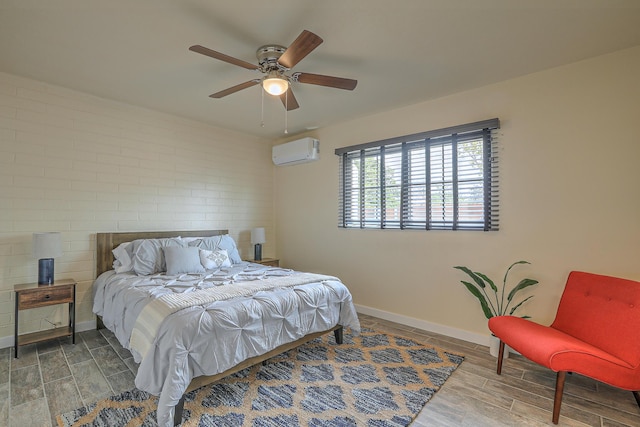 bedroom featuring wood finish floors, baseboards, a ceiling fan, and a wall mounted AC