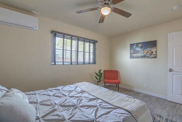 bedroom with a ceiling fan, wood finished floors, baseboards, and a wall mounted air conditioner