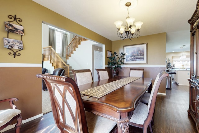 dining area with dark wood finished floors, a chandelier, stairs, and baseboards