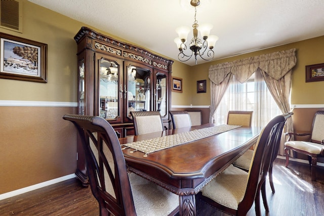 dining room with visible vents, baseboards, an inviting chandelier, and dark wood finished floors