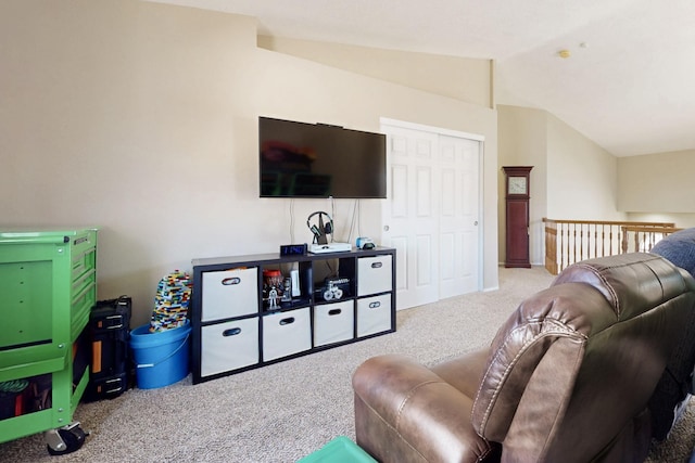 carpeted living area with vaulted ceiling