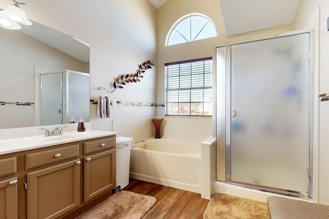 bathroom featuring vanity, a bath, wood finished floors, and a stall shower