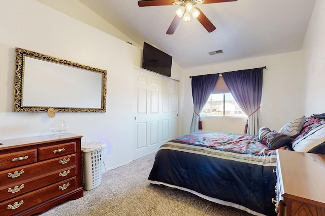 bedroom featuring visible vents, lofted ceiling, light colored carpet, and a ceiling fan