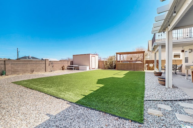 view of yard featuring a patio area, an outbuilding, a fenced backyard, and a shed