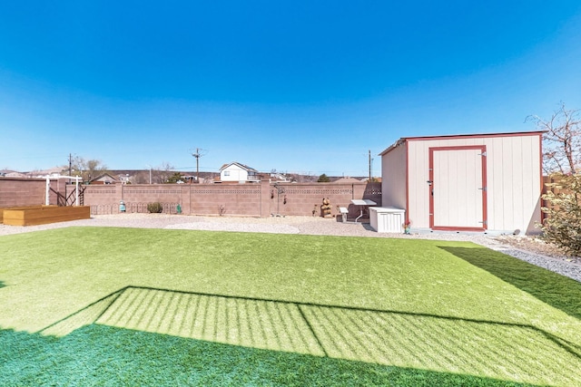 view of yard featuring a fenced backyard, a storage shed, and an outdoor structure